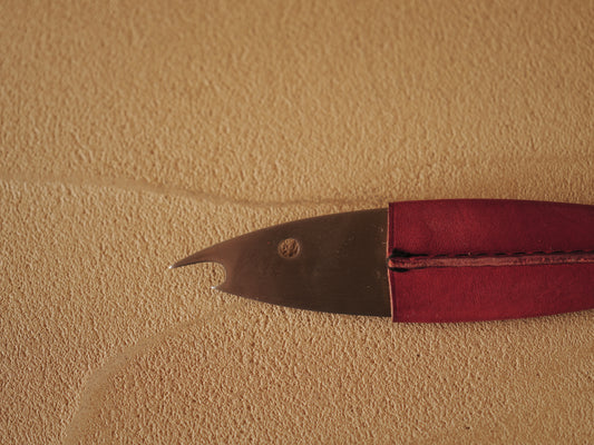 Carl Auböck One shaped like a fish in steel, covered in red leather. Model 4687