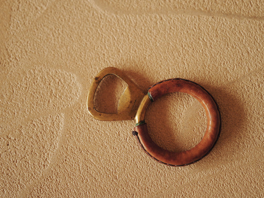 Carl Auböck One in brass with round handle covered with brown leather. Modell 4229.