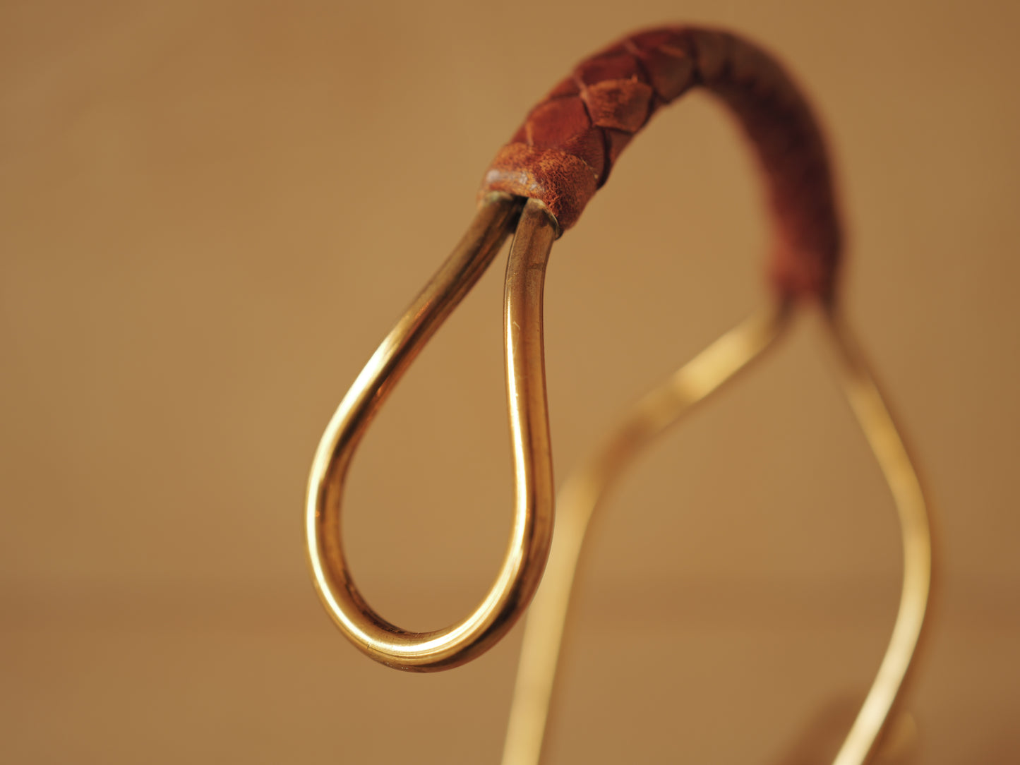 Carl Auböck model 3601 bottle holders of brass, braided leather, Illums Bolighus, Denmark 1957