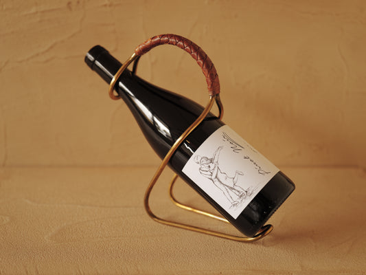 Carl Auböck model 3601 bottle holders of brass, braided leather, Illums Bolighus, Denmark 1957