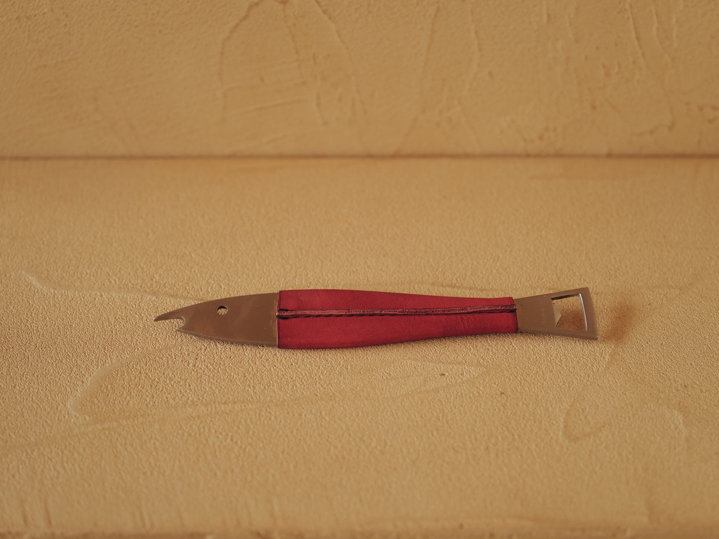 Carl Auböck One shaped like a fish in steel, covered in red leather. Model 4687