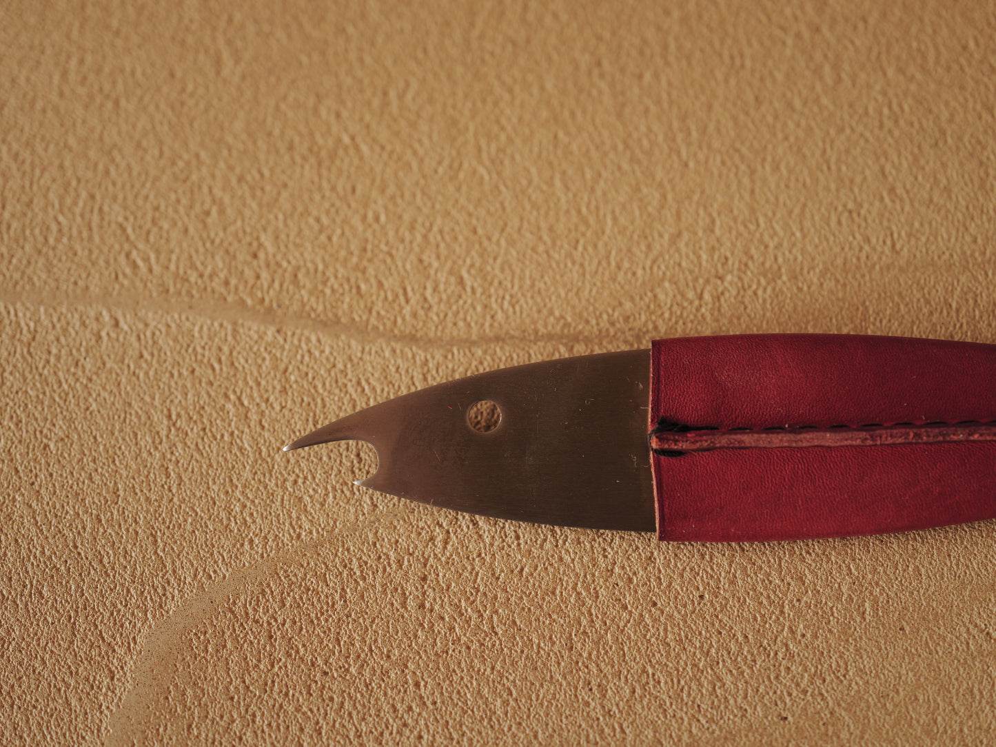Carl Auböck One shaped like a fish in steel, covered in red leather. Model 4687