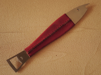 Carl Auböck One shaped like a fish in steel, covered in red leather. Model 4687