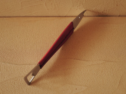 Carl Auböck One shaped like a fish in steel, covered in red leather. Model 4687