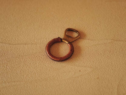 Carl Auböck One in brass with round handle covered with brown leather. Modell 4229.