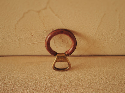 Carl Auböck One in brass with round handle covered with brown leather. Modell 4229.