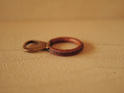 Carl Auböck One in brass with round handle covered with brown leather. Modell 4229.