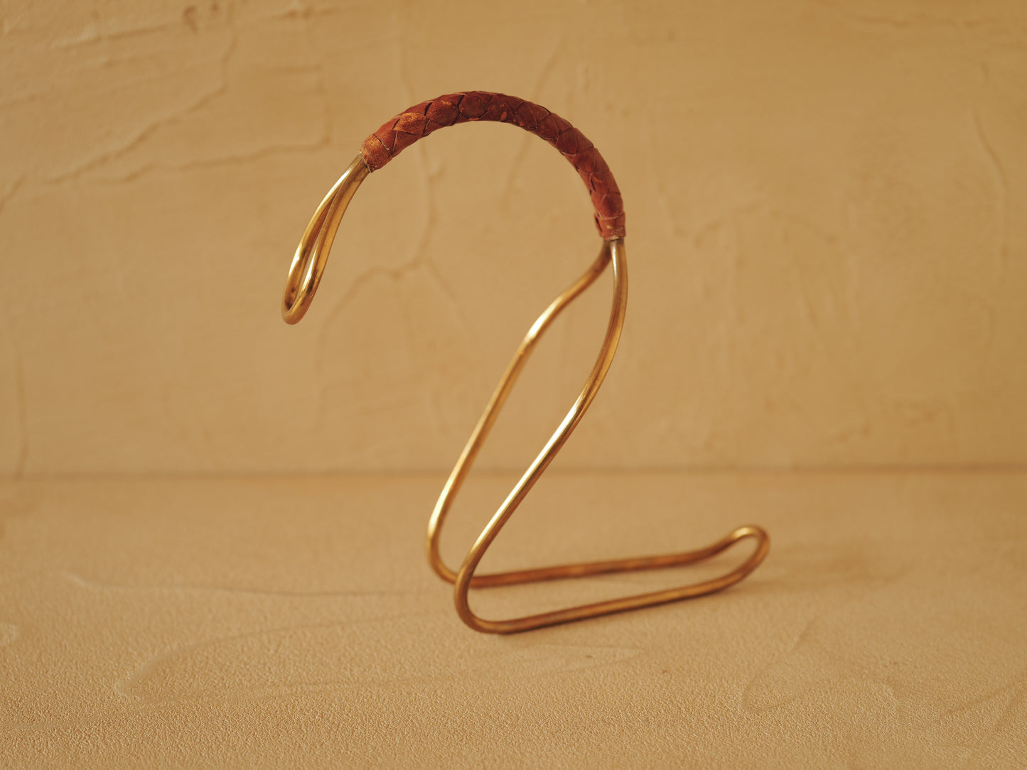 Carl Auböck model 3601 bottle holders of brass, braided leather, Illums Bolighus, Denmark 1957