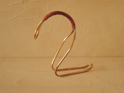 Carl Auböck model 3601 bottle holders of brass, braided leather, Illums Bolighus, Denmark 1957