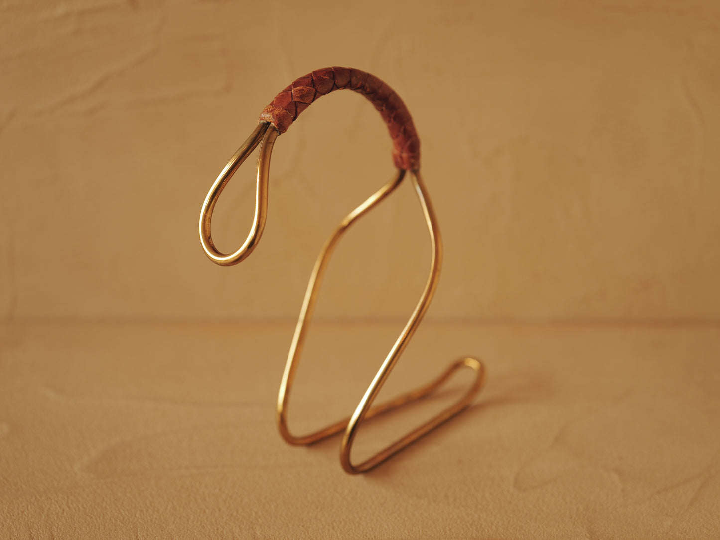 Carl Auböck model 3601 bottle holders of brass, braided leather, Illums Bolighus, Denmark 1957