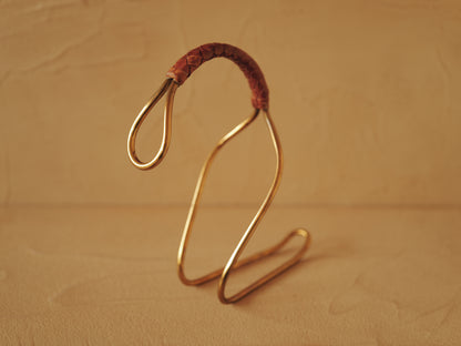 Carl Auböck model 3601 bottle holders of brass, braided leather, Illums Bolighus, Denmark 1957