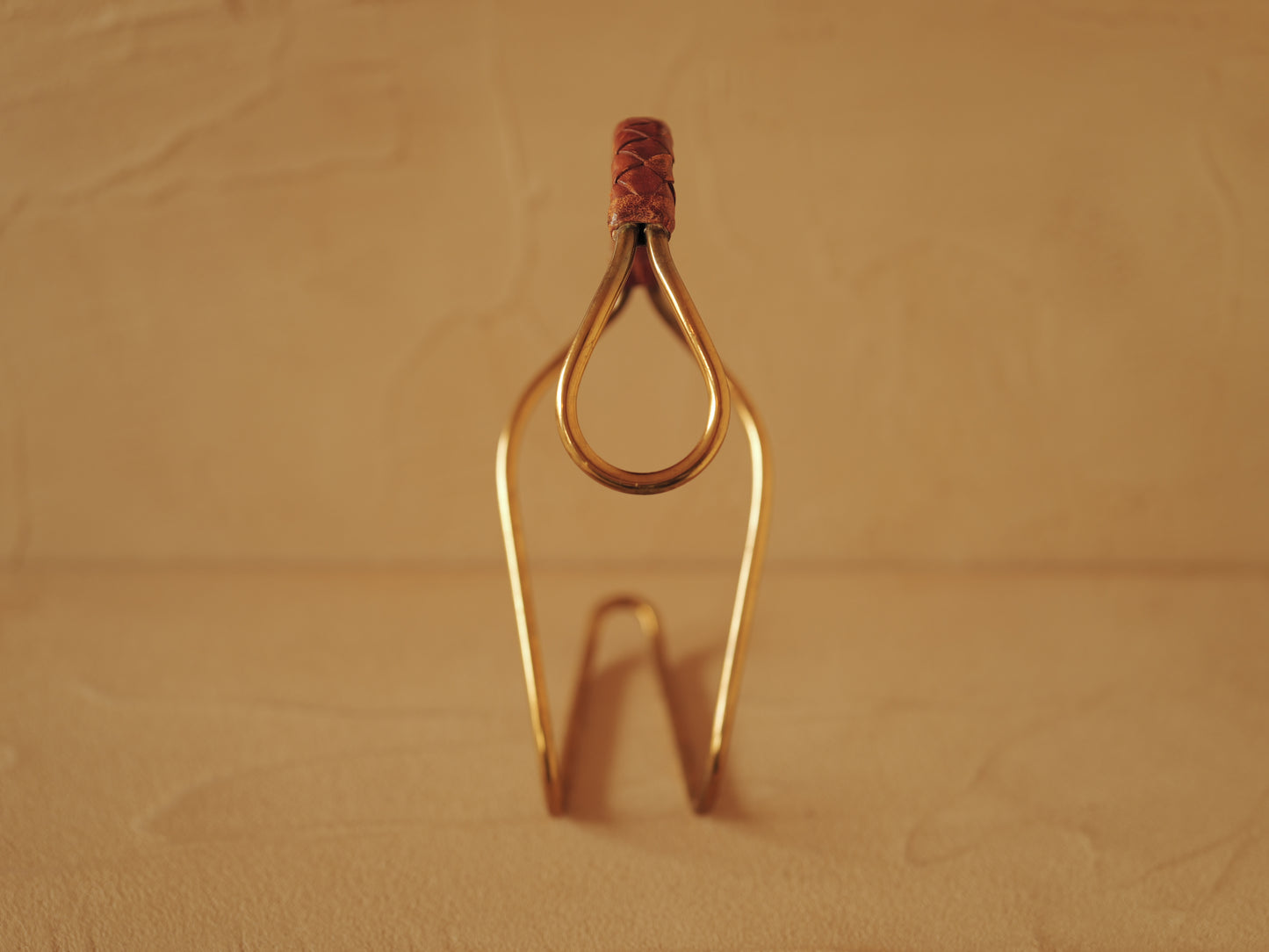 Carl Auböck model 3601 bottle holders of brass, braided leather, Illums Bolighus, Denmark 1957