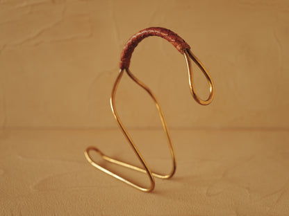 Carl Auböck model 3601 bottle holders of brass, braided leather, Illums Bolighus, Denmark 1957