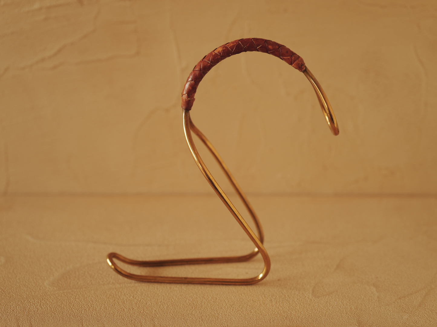 Carl Auböck model 3601 bottle holders of brass, braided leather, Illums Bolighus, Denmark 1957