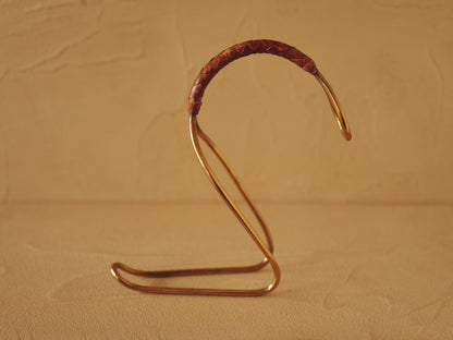 Carl Auböck model 3601 bottle holders of brass, braided leather, Illums Bolighus, Denmark 1957
