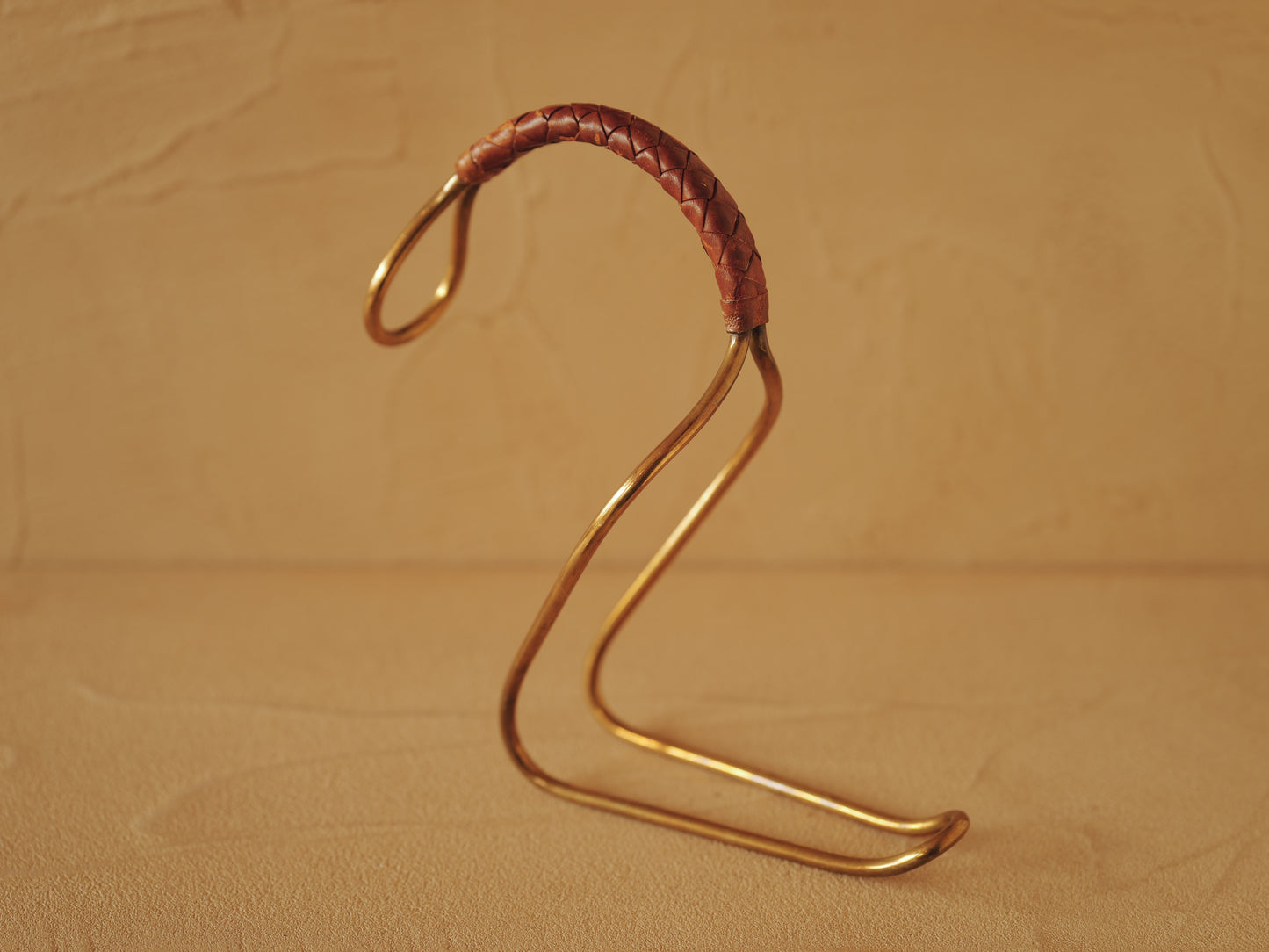 Carl Auböck model 3601 bottle holders of brass, braided leather, Illums Bolighus, Denmark 1957