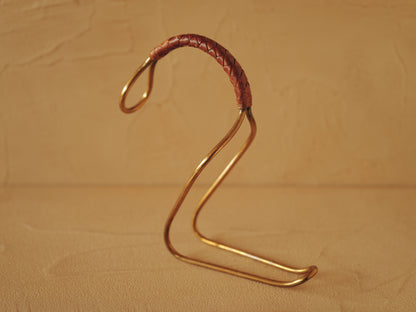 Carl Auböck model 3601 bottle holders of brass, braided leather, Illums Bolighus, Denmark 1957