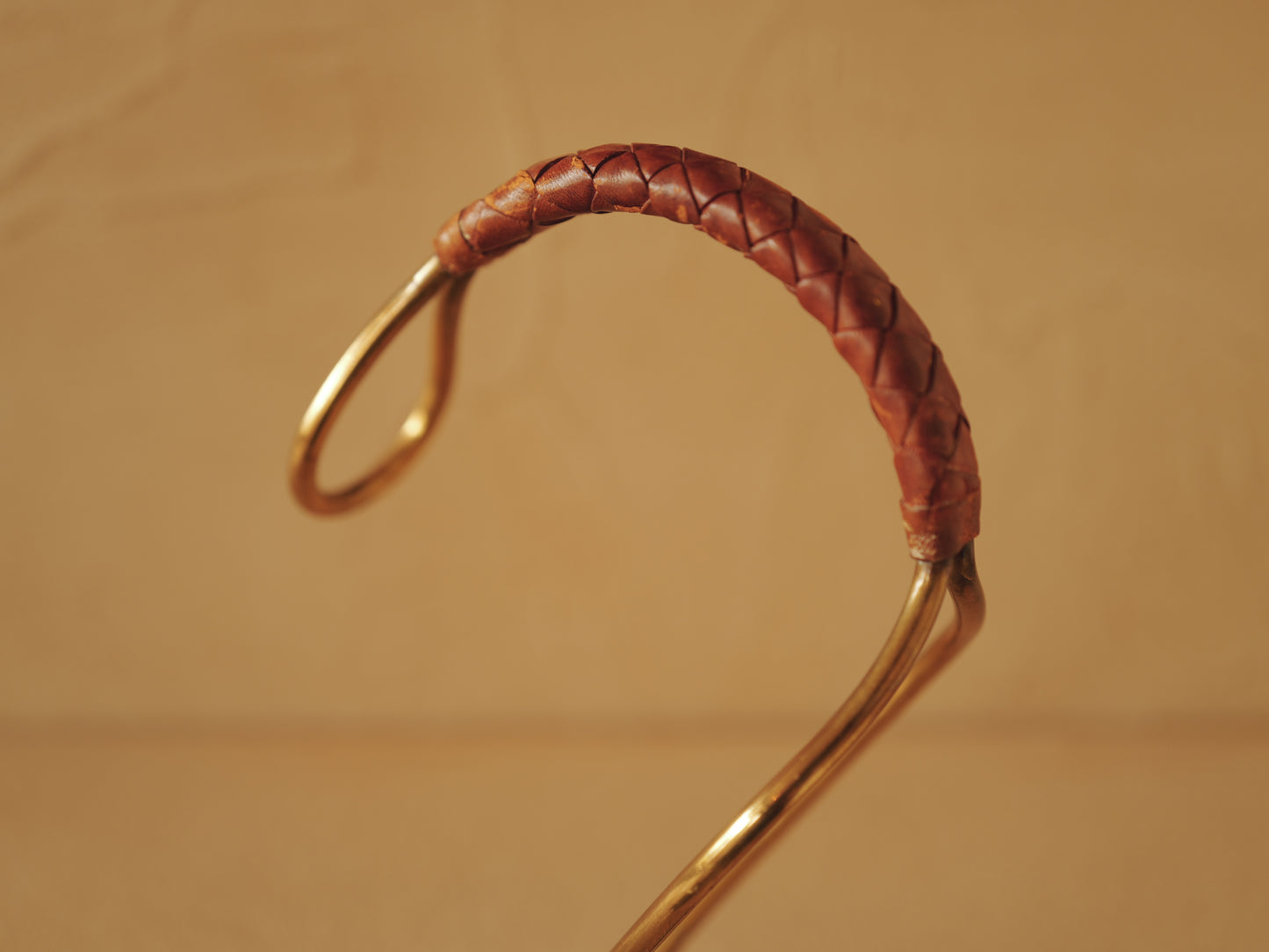 Carl Auböck model 3601 bottle holders of brass, braided leather, Illums Bolighus, Denmark 1957