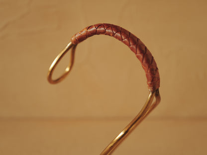 Carl Auböck model 3601 bottle holders of brass, braided leather, Illums Bolighus, Denmark 1957