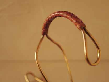 Carl Auböck model 3601 bottle holders of brass, braided leather, Illums Bolighus, Denmark 1957