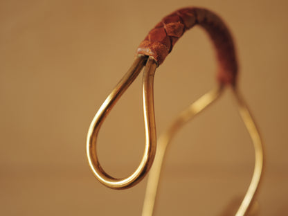 Carl Auböck model 3601 bottle holders of brass, braided leather, Illums Bolighus, Denmark 1957