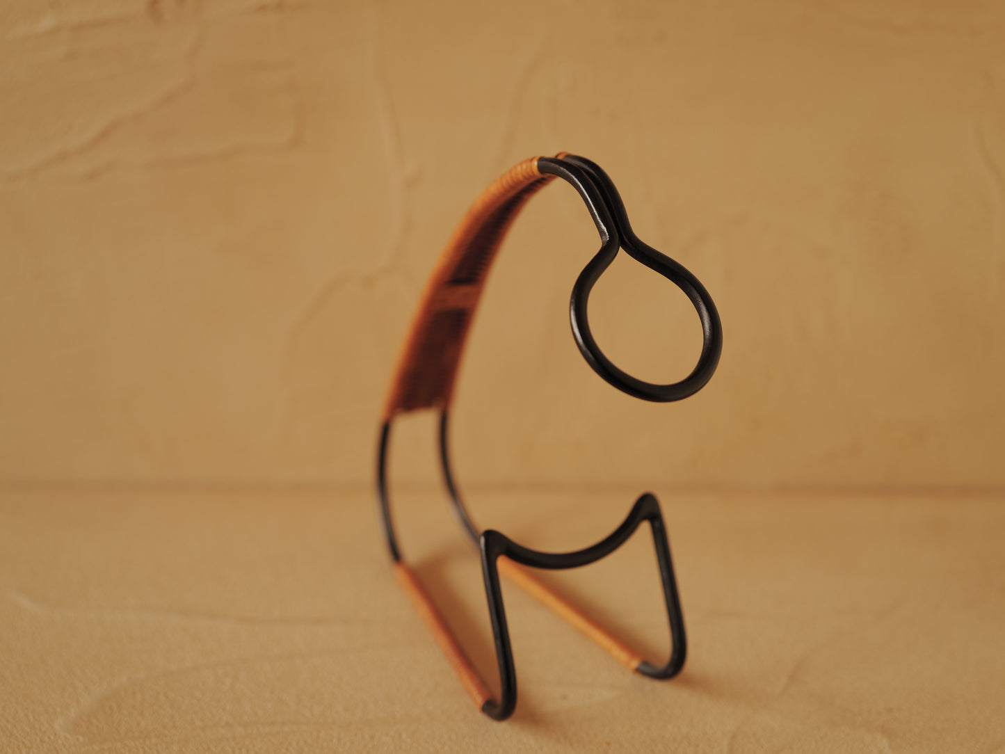 1960s Bottle holder in black lacquered metal wrapped with rattan