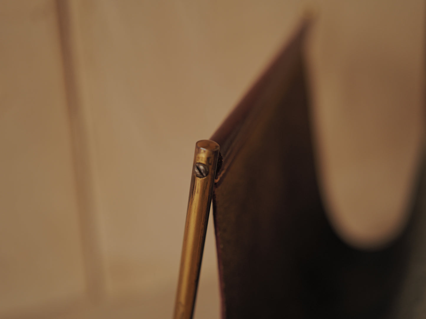 CARL AUBÖCK. Magazine holder in brass and leather, Austria
